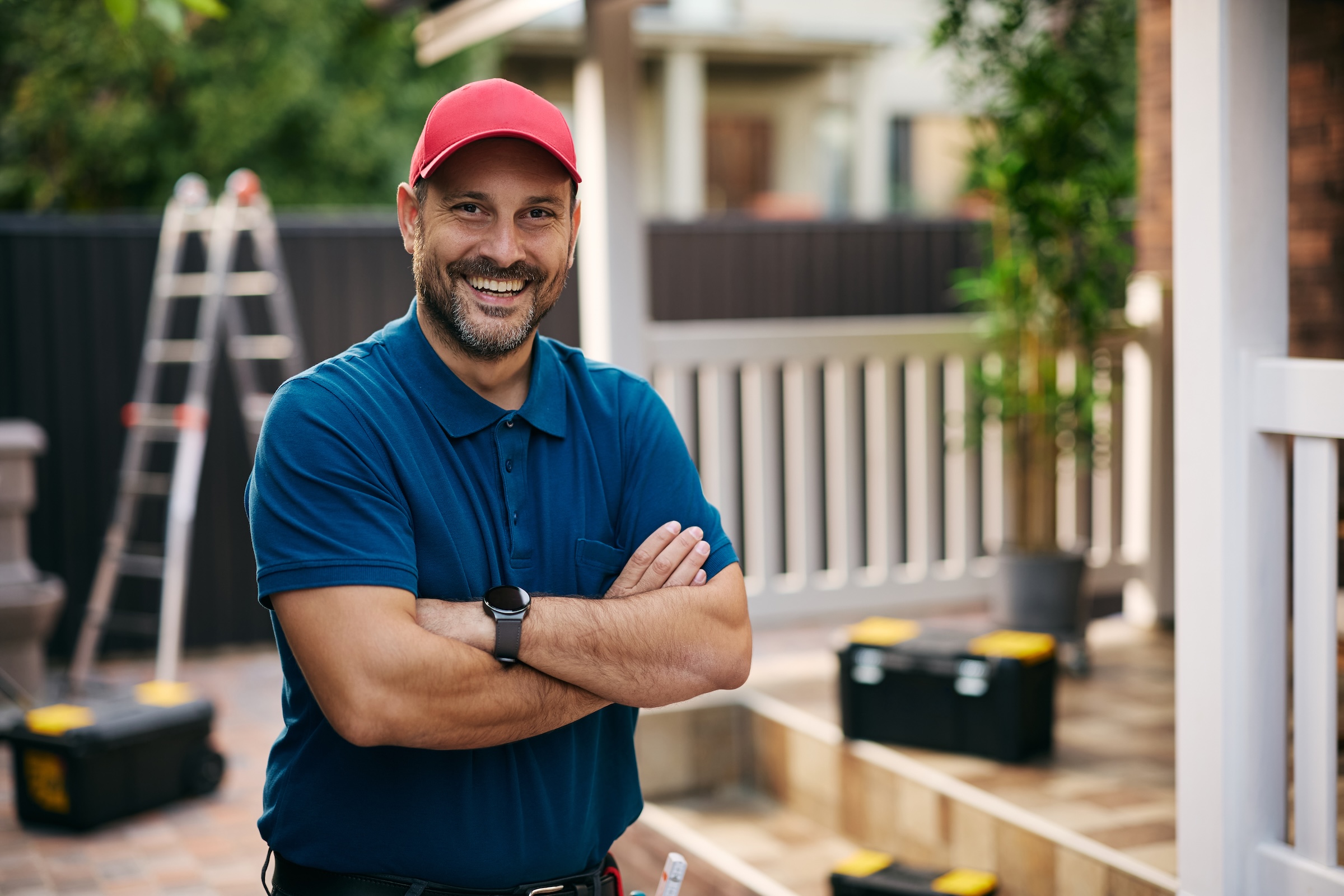 Portrait of happy handyman with arms crossed looking at camera. Copy space. 