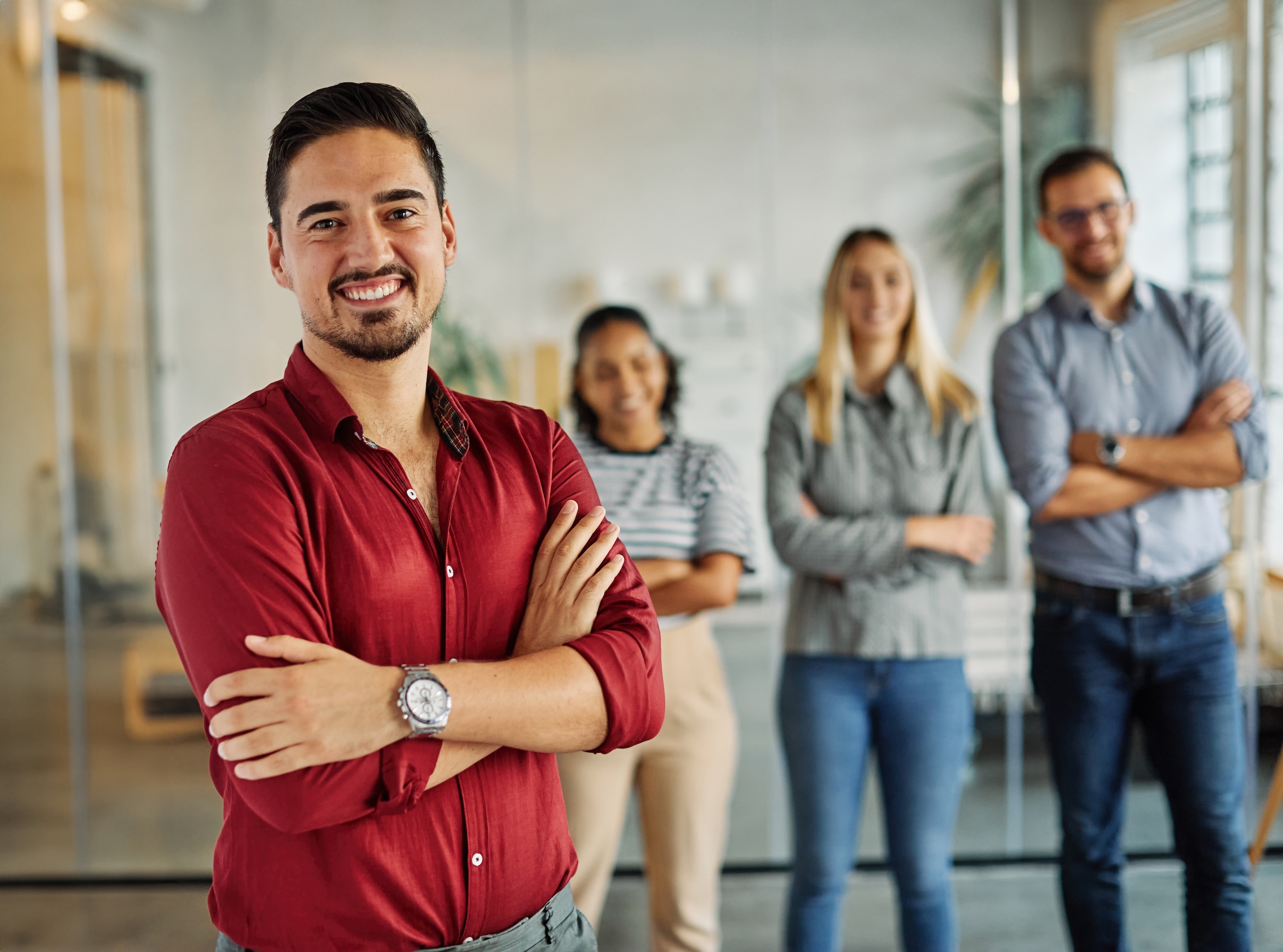 Portrait of a group of young business people having a meeting in the office. Teamwork and success concept, portrait of a young businessman